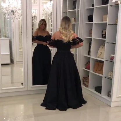 Elegante vestido de fiesta de encaje negro con hombros descubiertos y abertura en la pierna